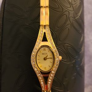 Ladies Relic Gold Watch with crystals on face of band.